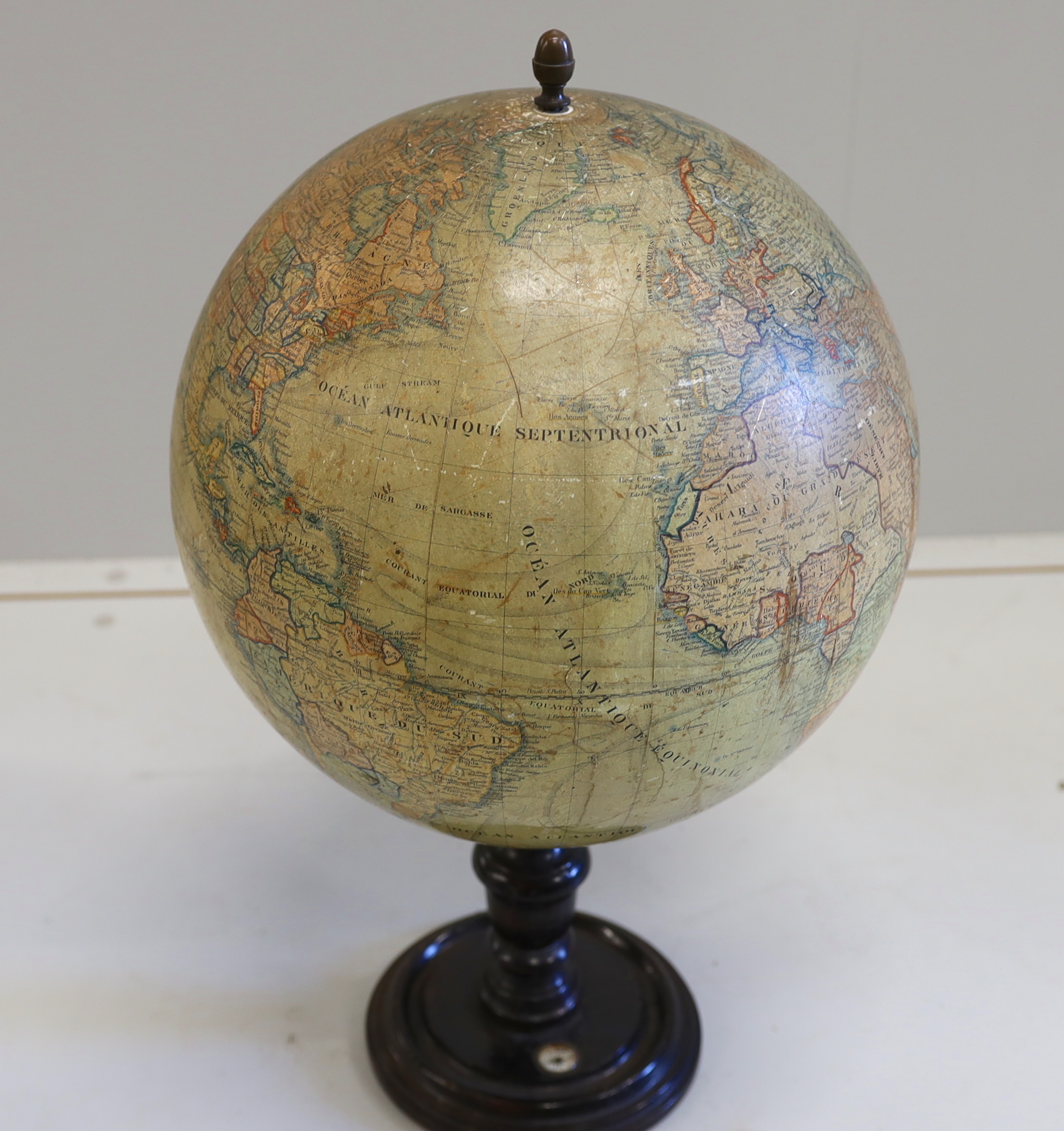A 19th century 12 inch French globe, ‘Globe Terrestre’ published by J. Lebegue & Cie., Paris, on ebonised pine stand with inset compass, 53cm high on stand
